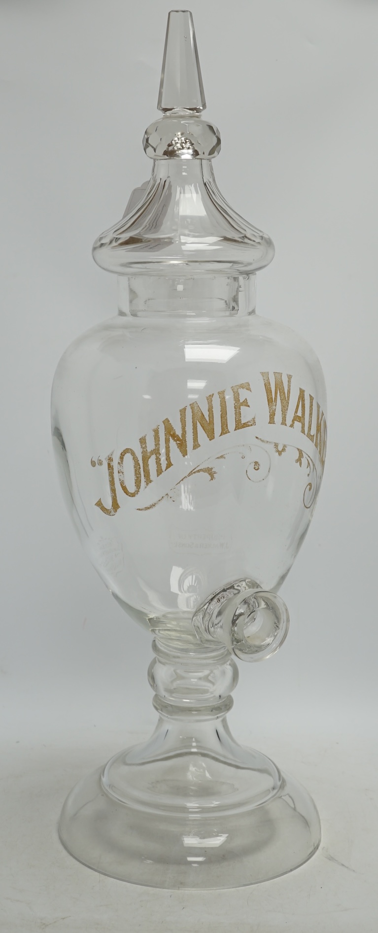 A Johnnie Walker glass advertising shop display whisky urn and cover, 65cm high. Condition - poor
